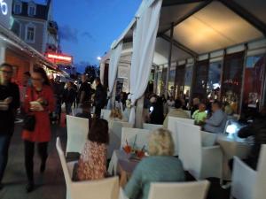 a group of people sitting in chairs outside a restaurant at Mi dzyzdroje Terraced House near Promenade in Międzyzdroje