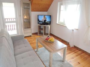 a living room with a couch and a table with fruit on it at Mi dzyzdroje Terraced House near Promenade in Międzyzdroje