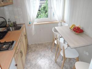 a kitchen with a table with a bowl of fruit on it at Mi dzyzdroje Terraced House near Promenade in Międzyzdroje