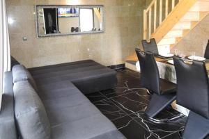 a living room with a couch and a table and chairs at Seaside Holiday Home winouj cie in Świnoujście