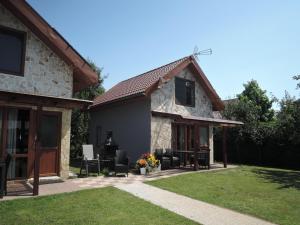 a stone house with a patio in front of it at Seaside Holiday Home winouj cie in Świnoujście