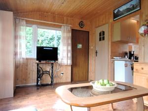 a kitchen with a table with a bowl of fruit on it at Bungalow near the Baltic Sea Beach in Wrzosowo