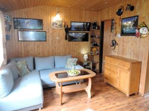 a living room with a couch and a table at Bungalow near the Baltic Sea Beach in Wrzosowo