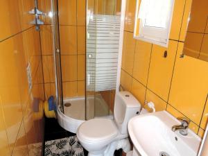 a bathroom with a toilet and a sink and a shower at Bungalow near the Baltic Sea Beach in Wrzosowo +31 photos