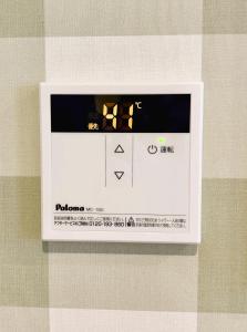 a box with a picture of a clock on a wall at Vivo House Hakomatsu - Apartment Stay in Fukuoka