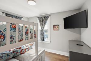 a bedroom with a bunk bed and a flat screen tv at Chestnut Comfort! in Dillsburg