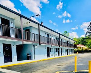 a building with a balcony on the side of it at Sunset Inn - Augusta in Augusta
