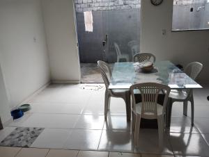 a dining room with a table and chairs at Casa em condomínio COP 30 in Ananindeua