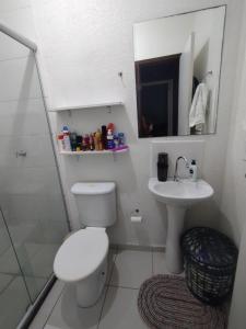a white bathroom with a toilet and a sink at Casa em condomínio COP 30 in Ananindeua +18 photos