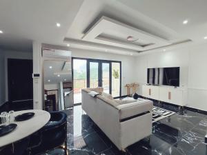 a living room with a couch and a table at Leboss Meublé in Yaoundé