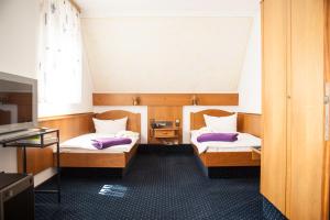 Postel nebo postele na pokoji v ubytování City Hotel Hanau