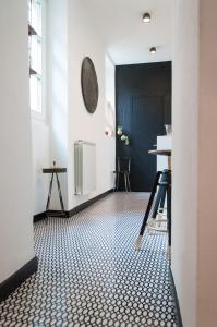 a hallway with a black and white tile floor at Suite Juvara in Como