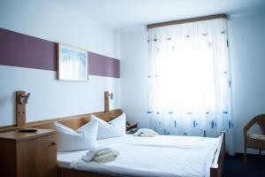 Postel nebo postele na pokoji v ubytování City Hotel Hanau