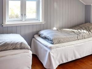 two beds in a room with a window at 8 person holiday home in FREI in Frei