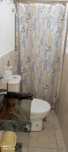 a bathroom with a toilet and a shower curtain at Departamentos Ines in Villa María