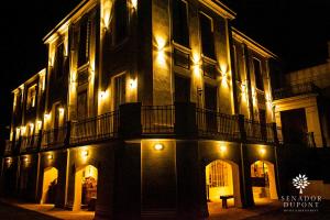 a large building with lights on it at night at Senador Dupont- Convento San Francisco & Arboles in Tigre +47 photos