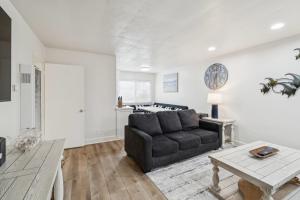 a living room with a couch and a table at 2 Bed Beach Condo #125 in Carpinteria