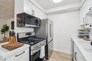 a kitchen with a stove and a refrigerator at 2 Bed Beach Condo #125 in Carpinteria