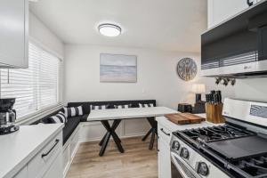 a kitchen with a table and a stove at 2 Bed Beach Condo #125 in Carpinteria +25 photos