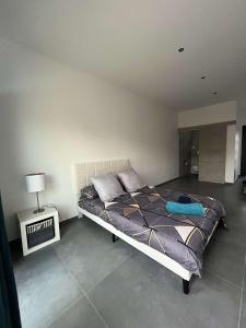 a bedroom with a bed and a lamp in it at Villa house 120m2 4 chambre 4 lit double in Les Tourrettes