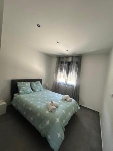 a bedroom with a bed with towels on it at Villa house 120m2 4 chambre 4 lit double in Les Tourrettes