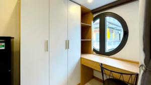 a room with a window and a desk with a chair at Lunaria Maison - Local Side in Ho Chi Minh City