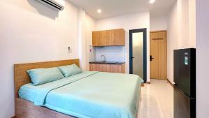 a bedroom with a large bed and a kitchen at Lunaria Maison - Local Side in Ho Chi Minh City +56 photos