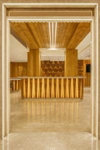 a lobby with a large glass door with a staircase at The Vanson Pride in New Delhi
