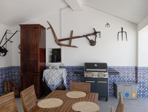 a kitchen with a table and chairs and a stove at Quinta dos Silvas in Santa Maria da Feira