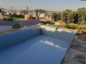 a swimming pool with blue tiles on a house at Quinta dos Silvas in Santa Maria da Feira