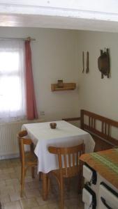 a dining room with a table and chairs and a window at Chalupa Pribylina in Pribylina
