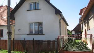 a white house with a fence in front of it at Chalupa Pribylina in Pribylina