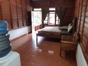 a bedroom with a bed in a room with wooden walls at vila Ciater in Ciater
