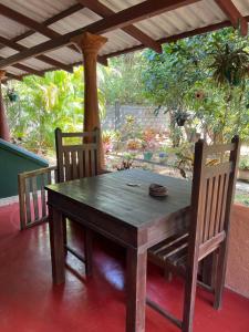 a wooden table and two chairs on a patio at Jaana Guest in Sigiriya
