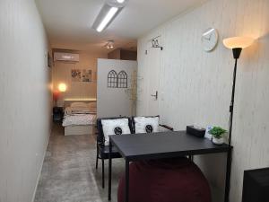 a room with a table and a bedroom with a bed at Greci Art Tokyo-Kinshicho Area Private room- in Tokyo