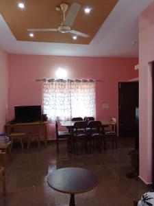 a living room with a table and chairs and a window at Lakshmi Nilaya Family Homestay on Hilltop-360 Degree View in Madikeri