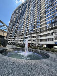 敖德萨ЖК Атмосфера первая линия моря место паркинг的大型建筑前的喷泉