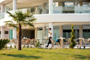 a man walking in front of a building at Sentido Thassos Imperial in Skala Rachoniou