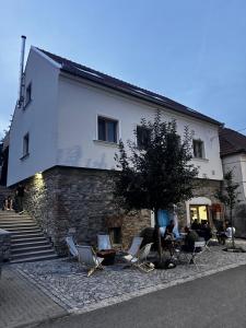 a group of people sitting in chairs in front of a building at Kopr in Přítluky