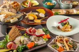 a table with many plates of food on it at KAMENOI HOTEL Nagatoro Yorii in Yorii