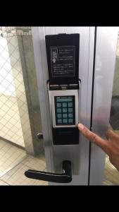 a person is pointing at a pay phone in an elevator at Apartment in Narita 123 in Narita