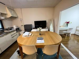 a kitchen with a table and chairs in a room at Apartment in Narita 123 in Narita