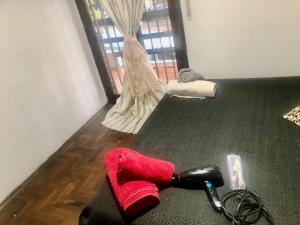 a red object on the floor in a room at Departamento habitación doble equipado full in Cordoba