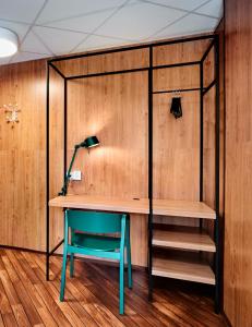 a room with a desk and a blue chair at Generator Stockholm in Stockholm