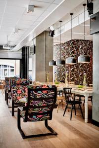 a dining room with chairs and tables and a wall of wine bottles at Generator Stockholm in Stockholm