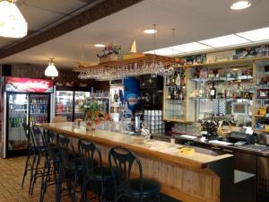 a bar in a restaurant with bar stools at KC's Country Inn in Vars
