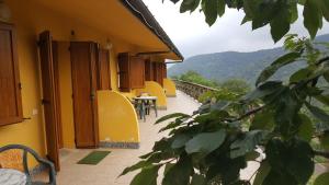 a balcony of a building with a table and chairs at La Vallata in Rovieto