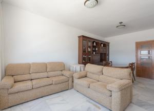 sala de estar con 2 sillas y sofá en Apartamento El Puerto Bahía, en Tarifa