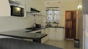 Kuchyň nebo kuchyňský kout v ubytování Asante Apartments