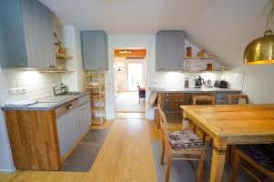 a kitchen with blue cabinets and a wooden table at Arber Lofts in Zwiesel in Zwiesel